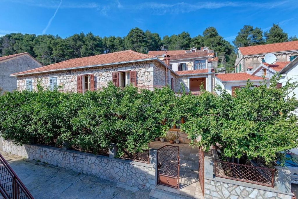 a house with a bunch of trees on a wall at Holiday house with a parking space Svirce, Hvar - 17682 in Vrbanj