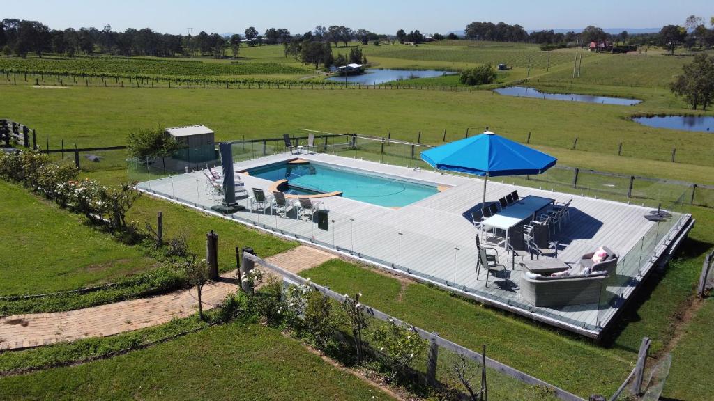 an overhead view of a swimming pool in a field at Burncroft Guesthouse in Lovedale
