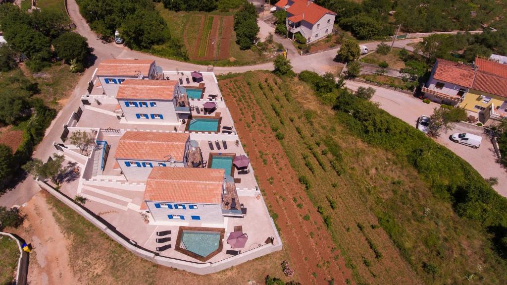 een uitzicht over een rij huizen op een heuvel bij Family friendly house with a swimming pool Vrh, Krk - 17760 in Vrh
