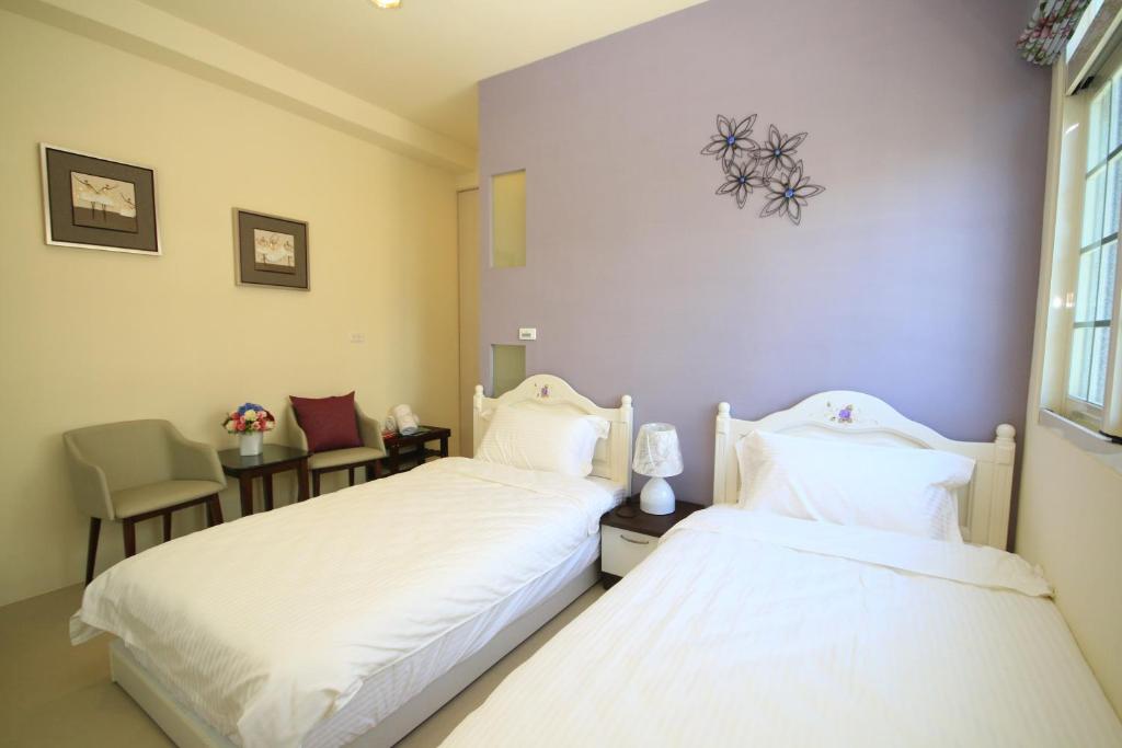 Postel nebo postele na pokoji v ubytování Sunny Breeze Garden Homestay