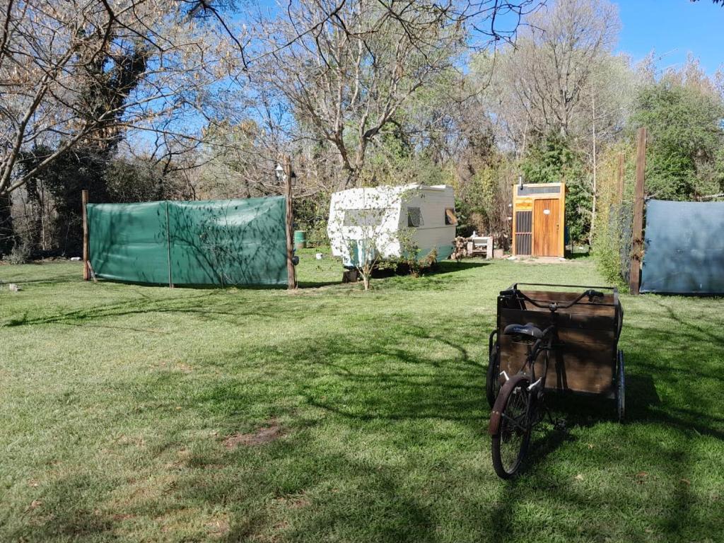 a bike parked in the grass in a field at Tiny House Ventania in Sierra de la Ventana