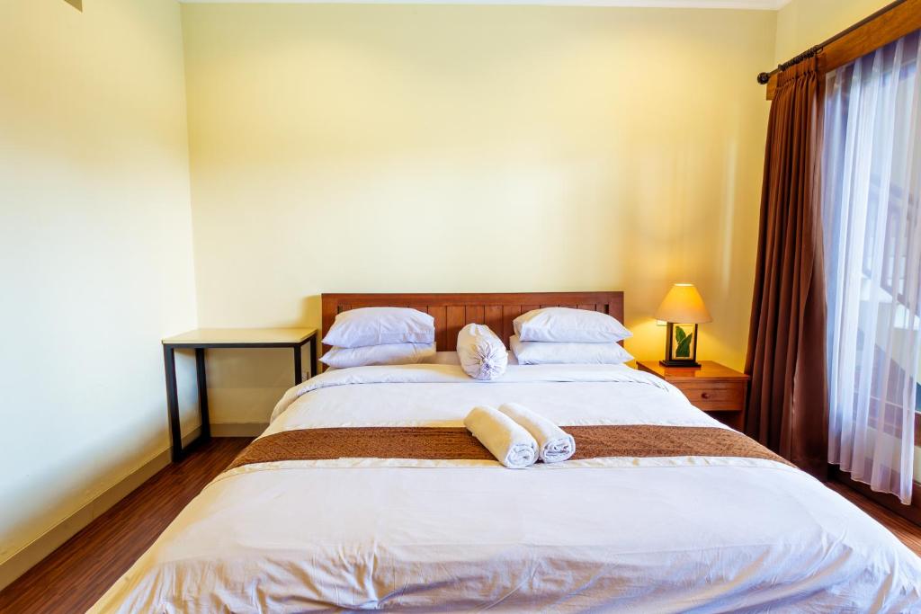 Postel nebo postele na pokoji v ubytování Sakura Guest House