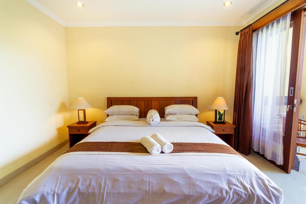 Postel nebo postele na pokoji v ubytování Sakura Guest House