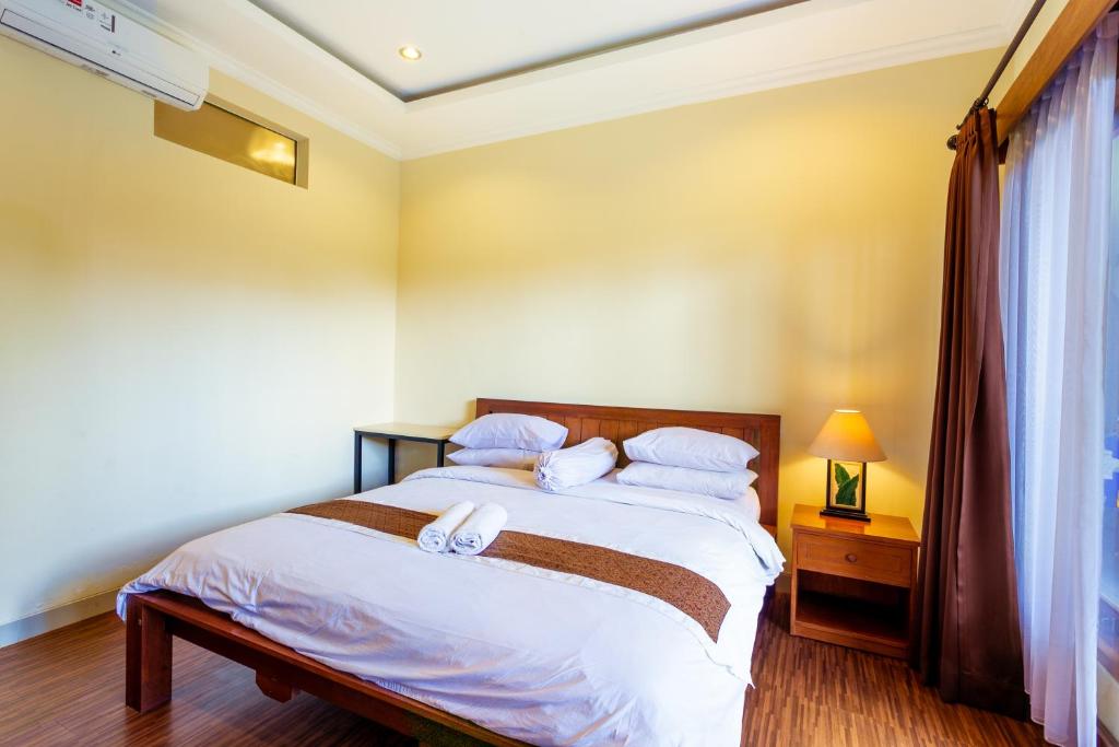 Postel nebo postele na pokoji v ubytování Sakura Guest House