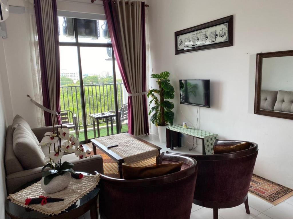 a living room with a couch and chairs and a window at Maz Stayhouse in Alor Setar