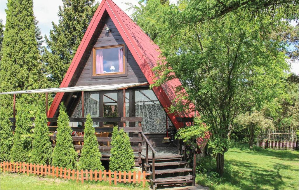 a tiny house with a red roof at 2 Bedroom Nice Home In Olsztynek in Olsztynek