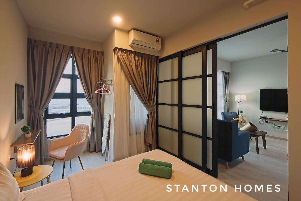 a bedroom with a bed and a living room at Jesselton Quay HOMESTAY by Stanton Homes in Kota Kinabalu