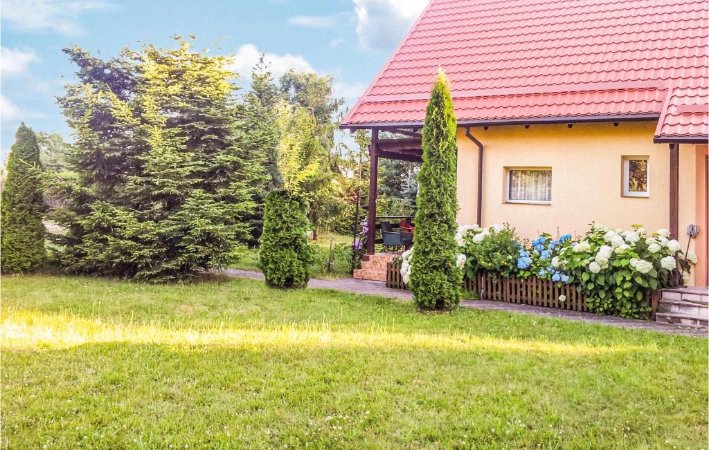 a house with a red roof and a fence at Stunning Home In Golubie With Wifi in Gołubie