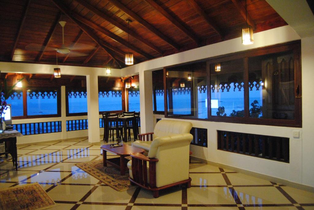 a living room with a view of the ocean at La Veranda Di Serena in Unawatuna