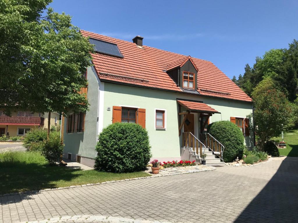 a house with an orange roof on a street at Haeberlhaus in Königstein in der Oberpfalz