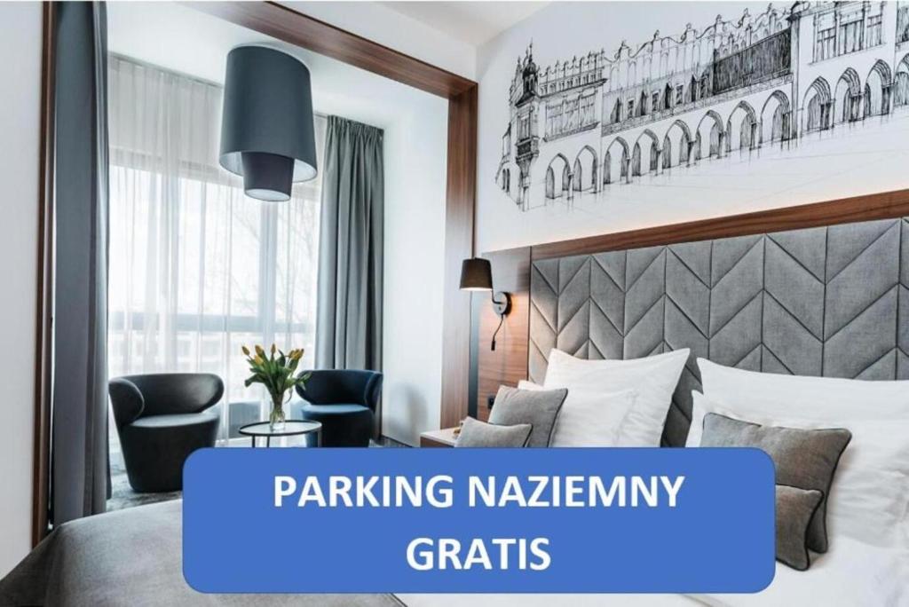 a hotel room with a bed and a sign that says parking napkininity grids at Garden Square Hotel in Kraków