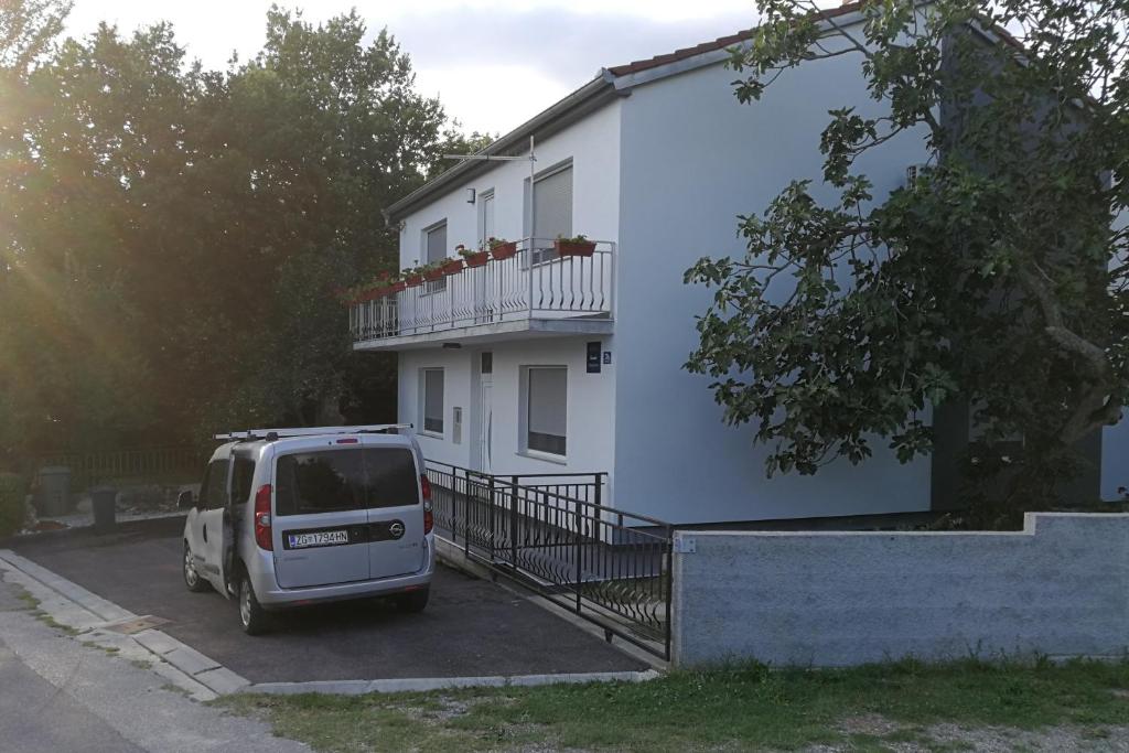 a white van parked in front of a house at Apartments with a parking space Kamenjak, Crikvenica - 18348 in Grižane