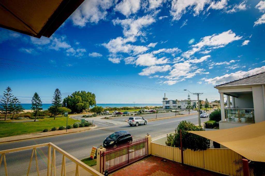 a view from a balcony of a house with a road at Esplanade Apartments at West Beach in Adelaide