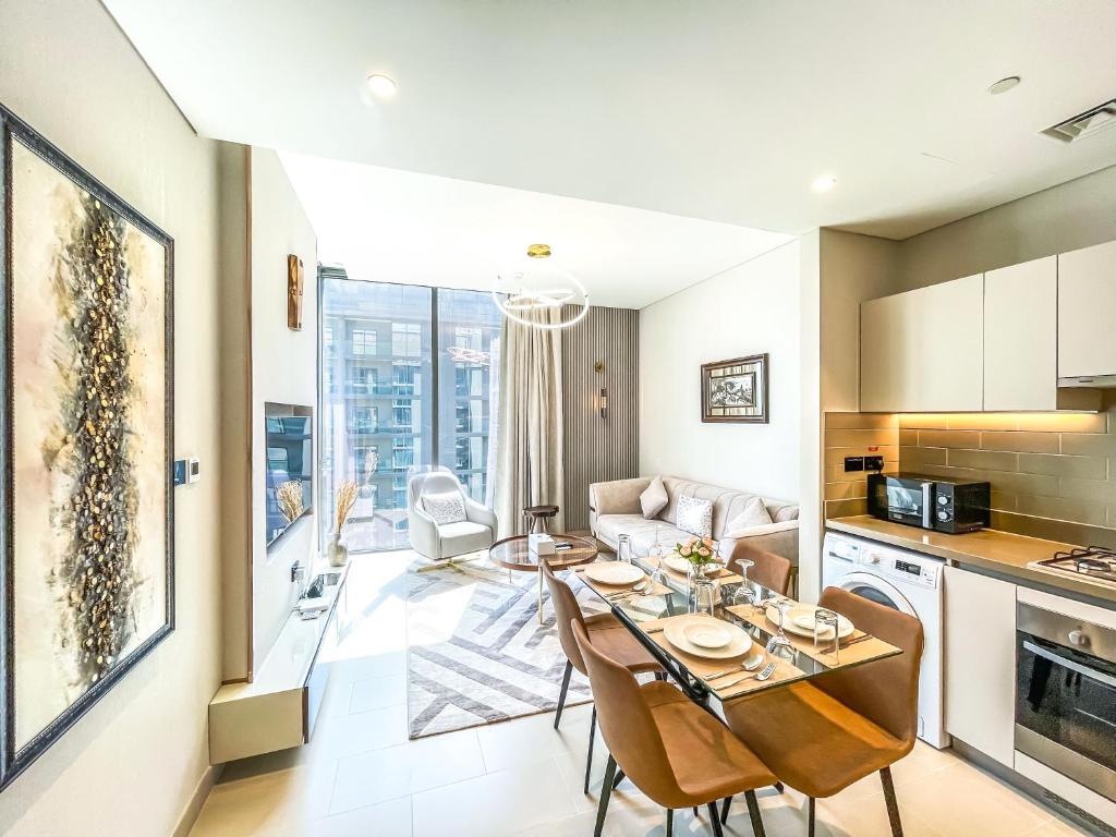 a kitchen and living room with a table and chairs at STAY BY LATINEM Luxury 1BR Holiday Home CV A2604 near Burj Khalifa in Dubai