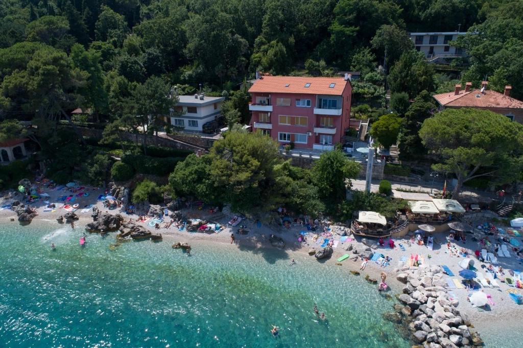 an aerial view of a beach with people in the water at Rooms by the sea Moscenicka Draga, Opatija - 18473 in Mošćenička Draga