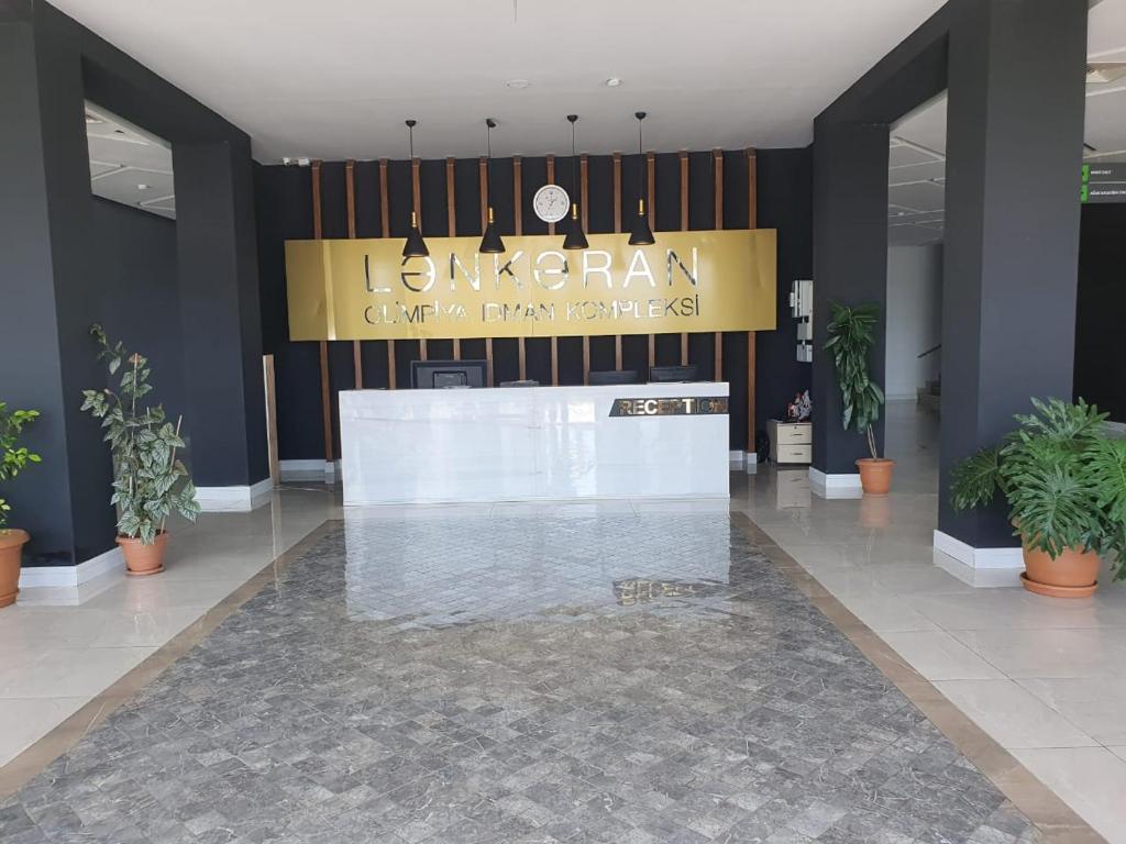 a lobby with a reception desk in a building at Lankaran Olimpiya Hotel in Lankaran