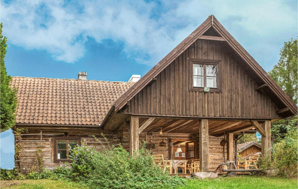 a log cabin with a gambrel roof at 4 Bedroom Stunning Home In Milakowo in Miłakowo