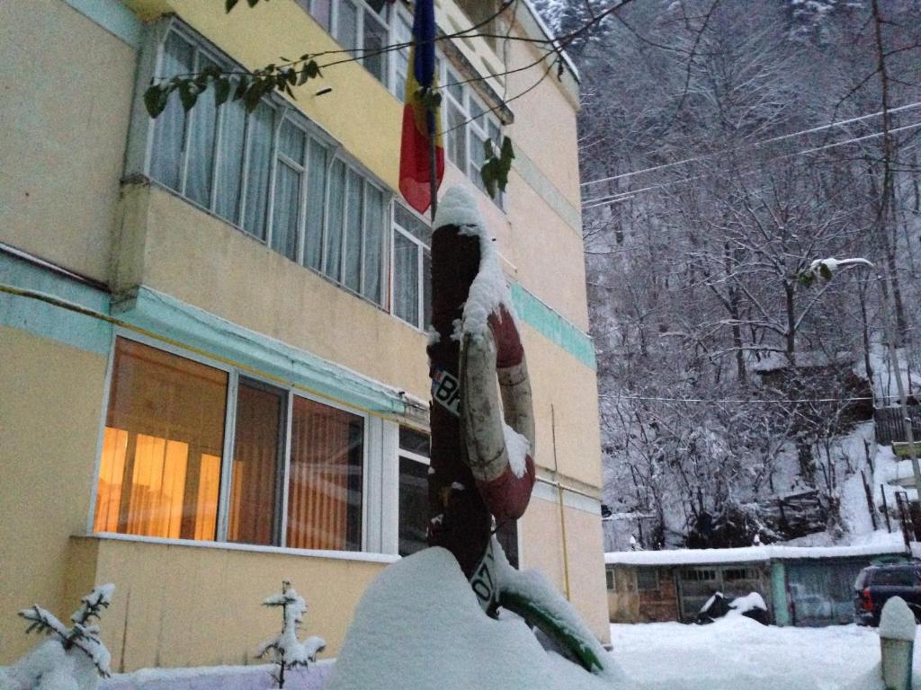 a building with snow on the side of it at Apartament Slanic Moldova in Slănic-Moldova