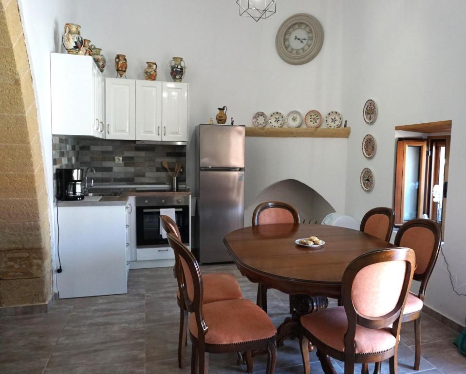 a kitchen with a table and a refrigerator at Amalia's Traditional Home in Paradisi in Paradeísion