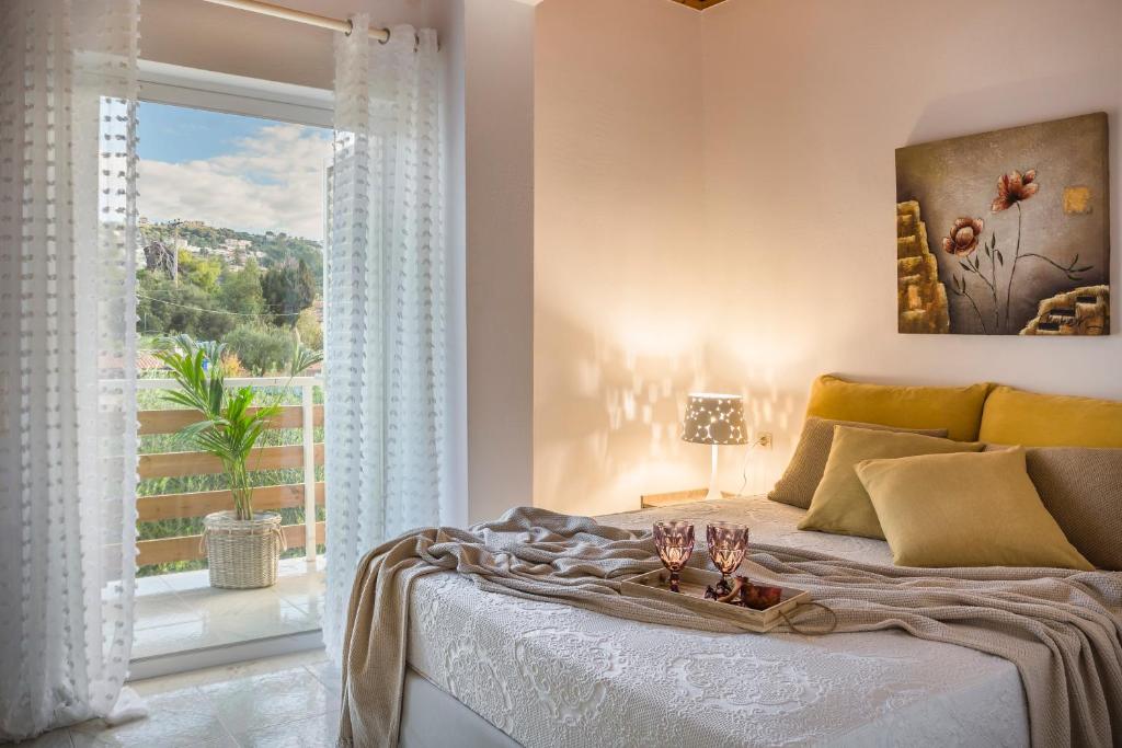 a bedroom with a bed and a large window at Malibu Superior Apartment in Argostoli