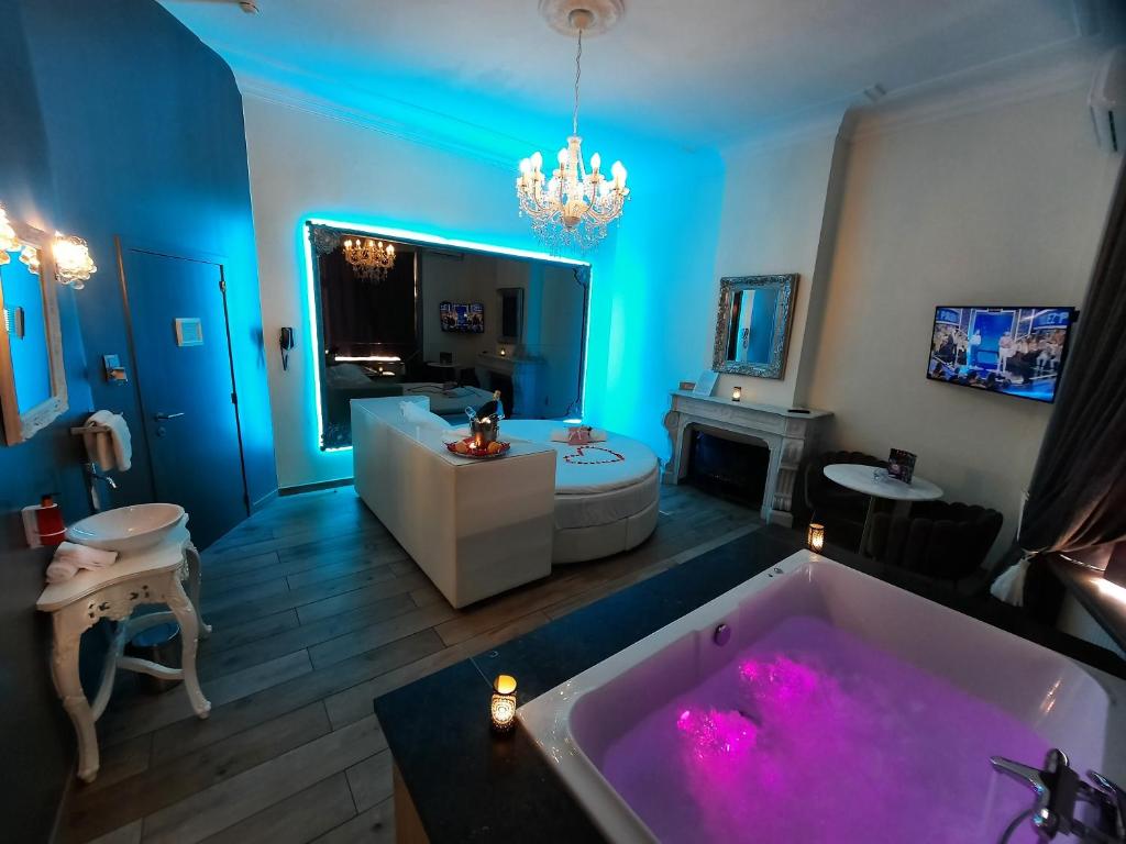 a large bathroom with a tub with pink lighting at Ô Secret in Liège