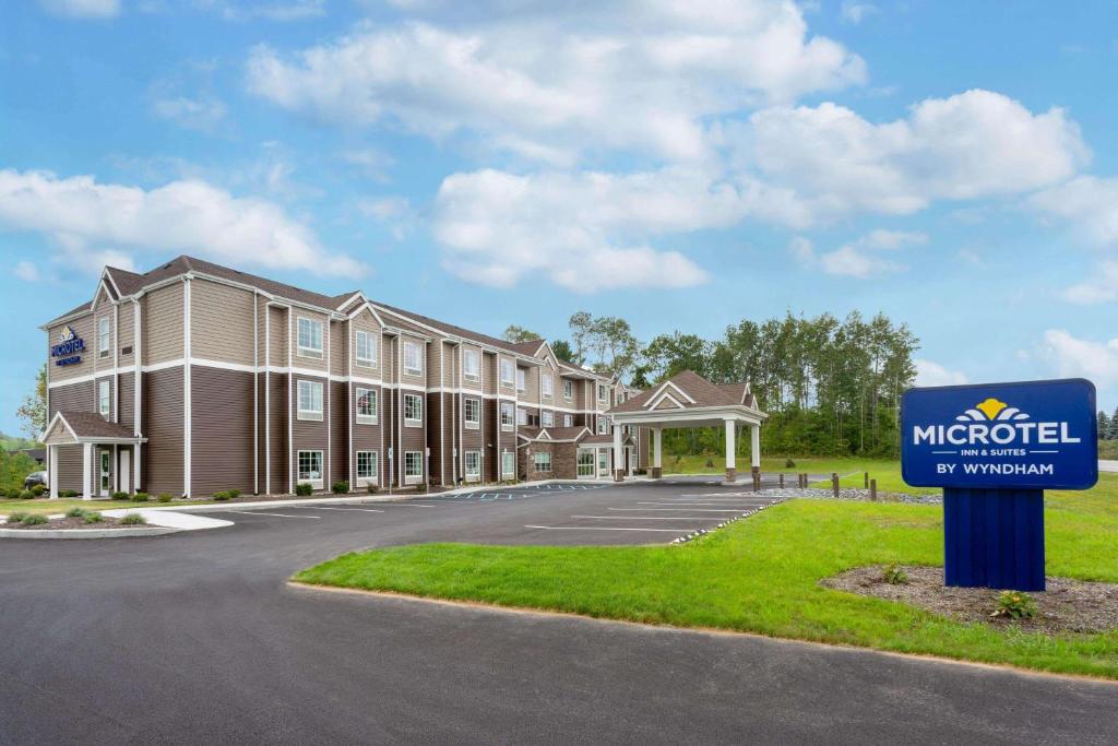 a building with a sign in front of it at Microtel Inn & Suites by Wyndham Amsterdam NY in Amsterdam