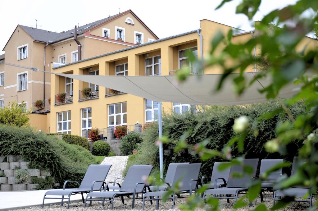 a row of chairs in front of a building at Hotel Karel IV. in Turnov