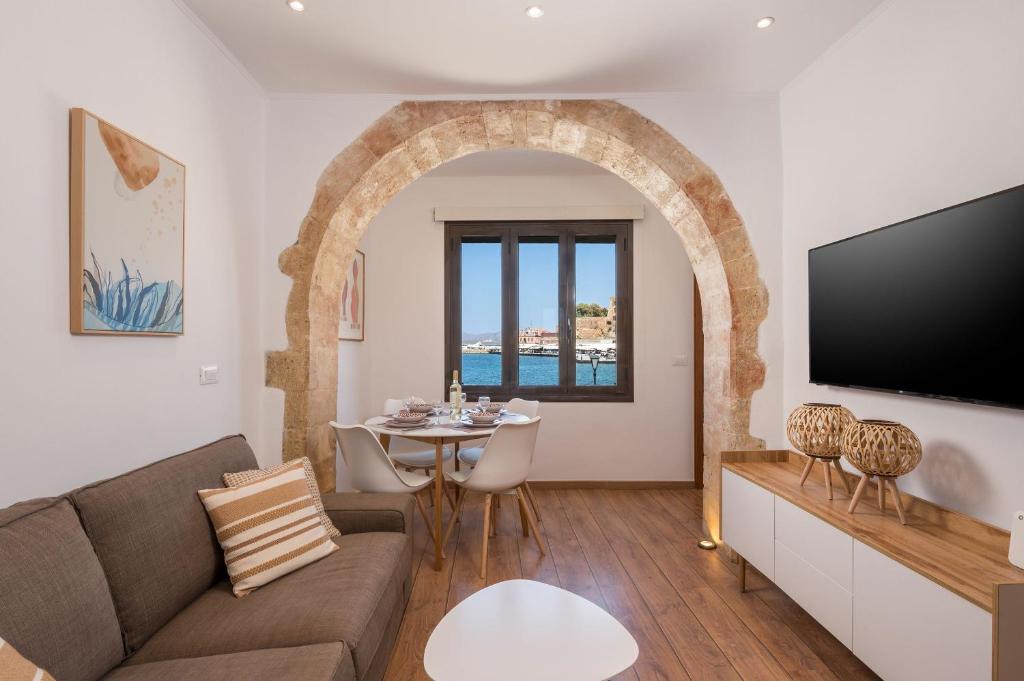 a living room with a couch and a table at Pasifai Residence - Chania old town in Chania Town