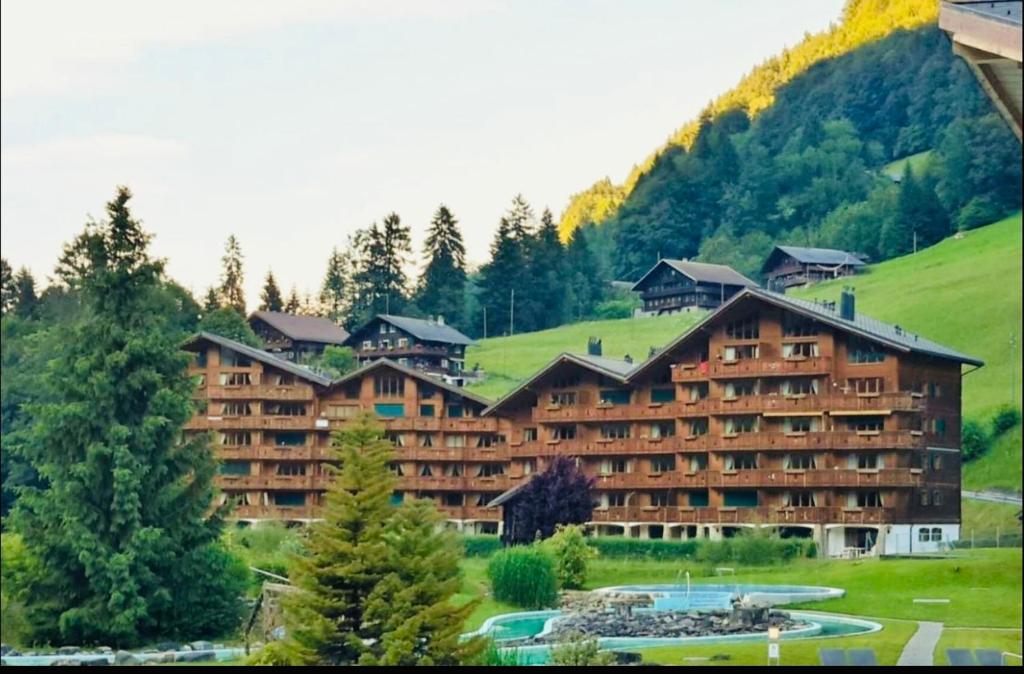 a large hotel with a mountain in the background at Studio , Val-d’Illiez in Val-d'Illiez