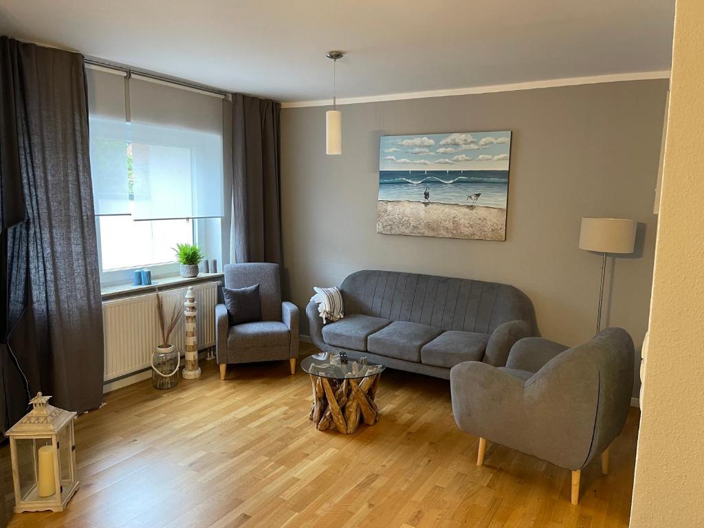 a living room with a couch and a chair at Family House in Kappeln