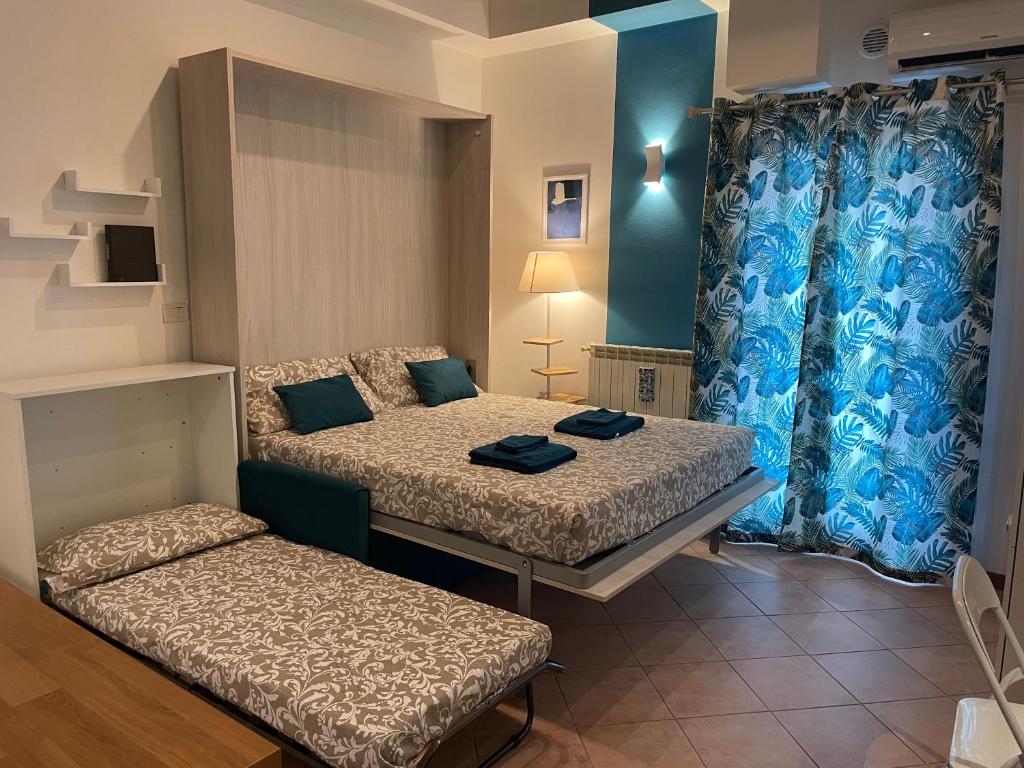 a small room with two beds and a couch at Porta Romana Bella in Milan