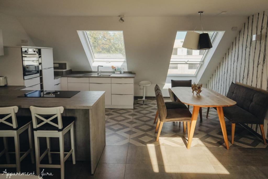 a kitchen and dining room with a table and chairs at Apartements Zum Roten Lamm in Bad Krozingen
