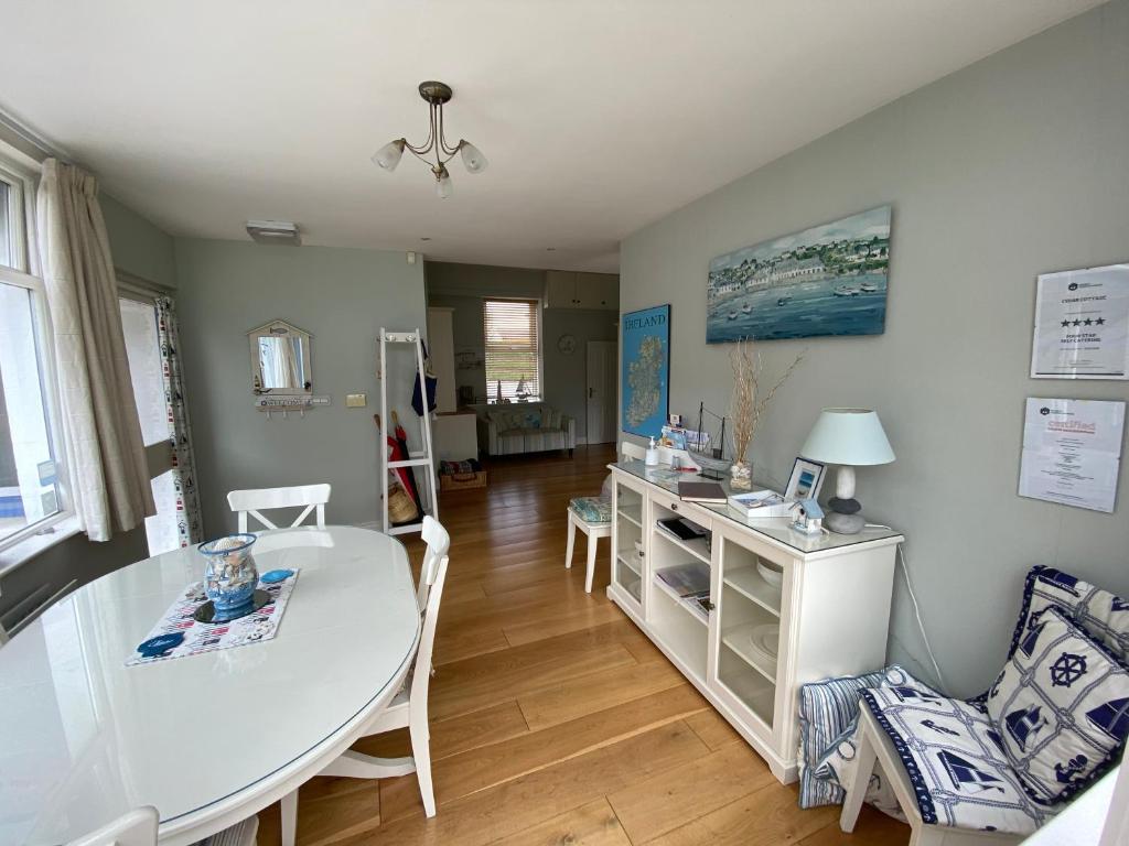 een woonkamer met een witte tafel en stoelen bij Cedar Cottage in Warrenpoint