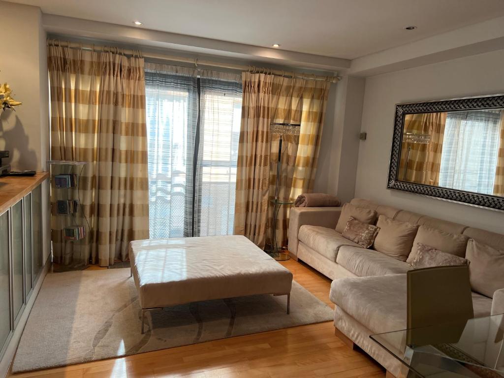 a living room with a couch and a table at Central London 1 bed Apartment in London