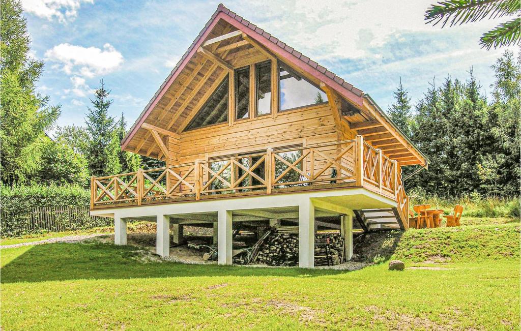 a house that is on top of a grass field at Amazing Home In Biskupiec With 2 Bedrooms in Biskupiec