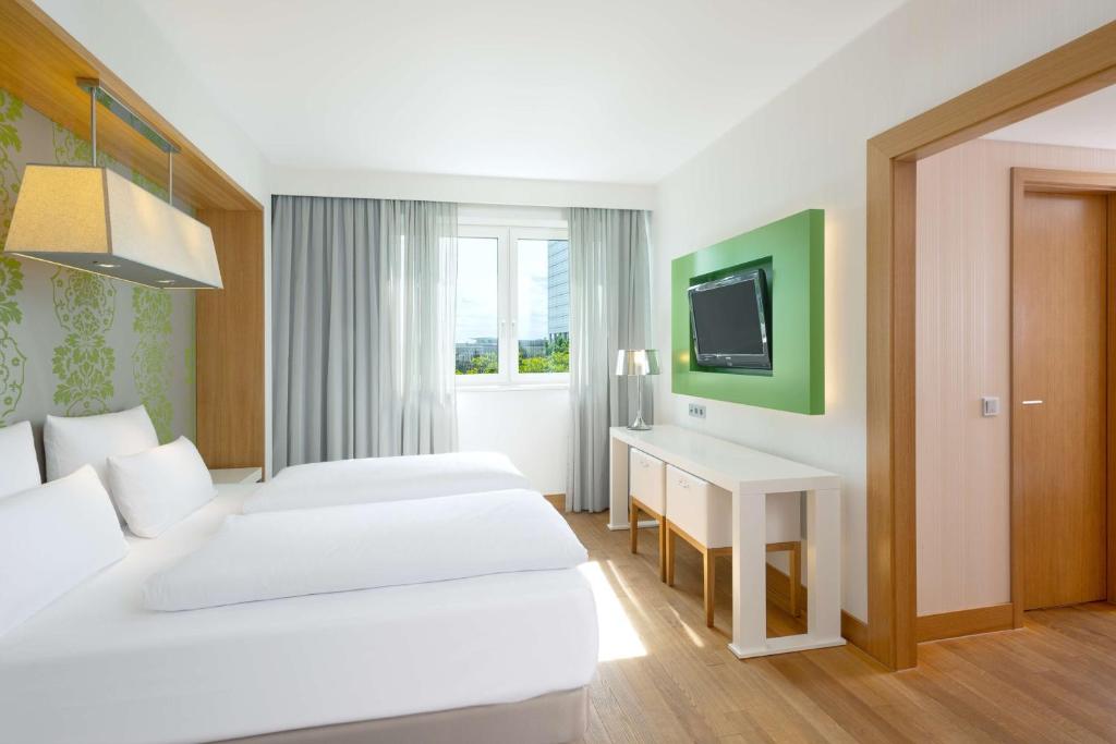 Cama ou camas em um quarto em NH Frankfurt Messe