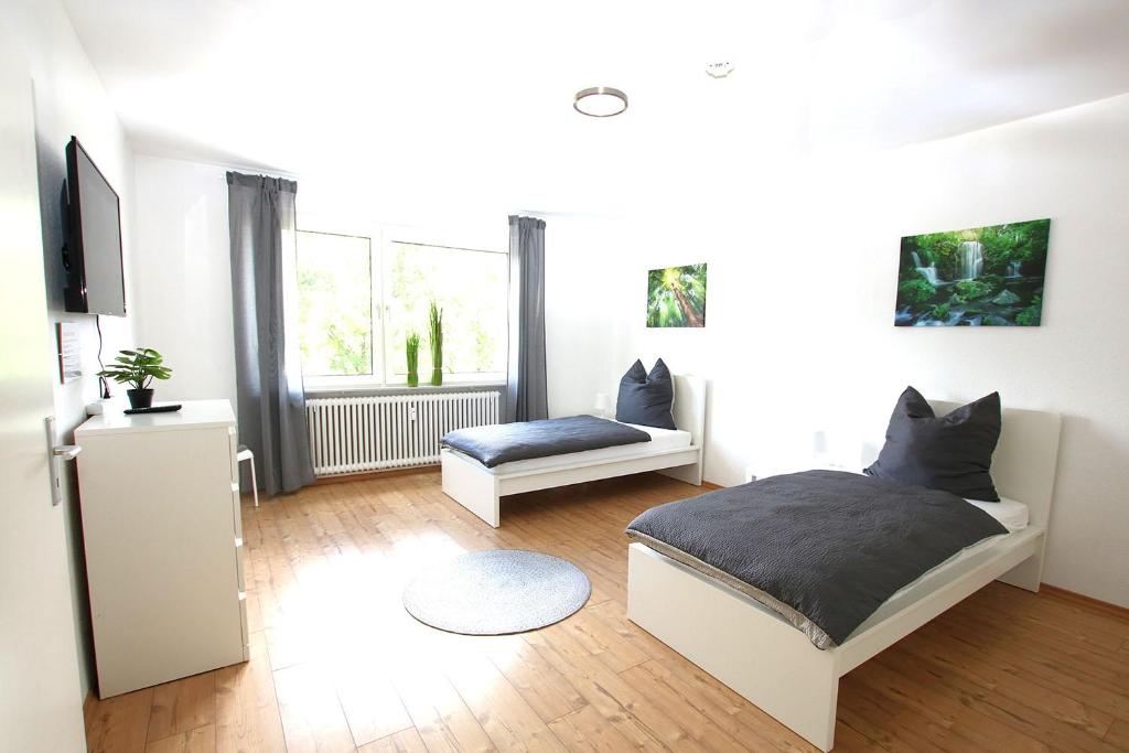 a bedroom with a bed and a couch in it at Spacious Apartment with Balcony in Wetzlar