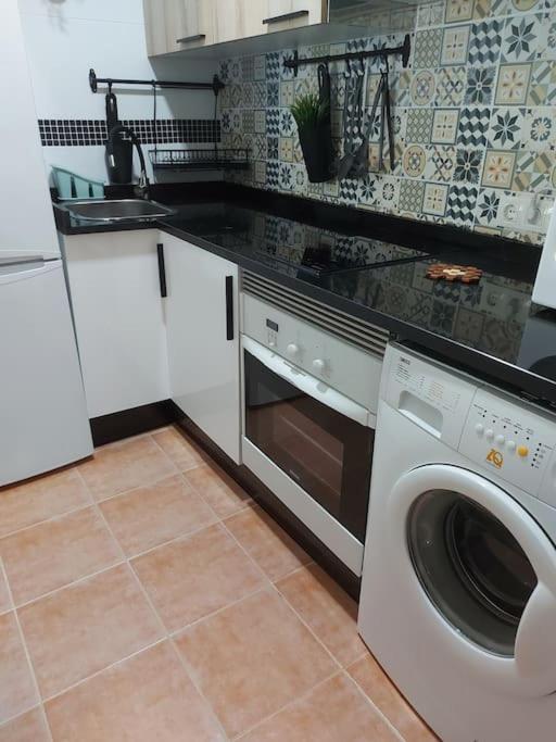 A kitchen or kitchenette at APARTAMENTO PLAYA DE ESTORDE - Piscina y playa en el corazon da Costa da Morte