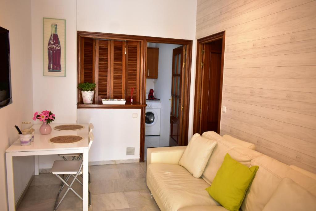 a living room with a couch and a table at Apartamento Dueñas in Seville