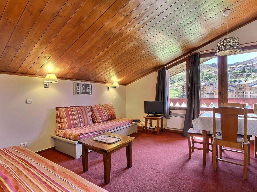a living room with a bed and a table and a couch at Appartement Plagne Soleil, 2 pièces, 5 personnes - FR-1-455-7 in Plagne Villages