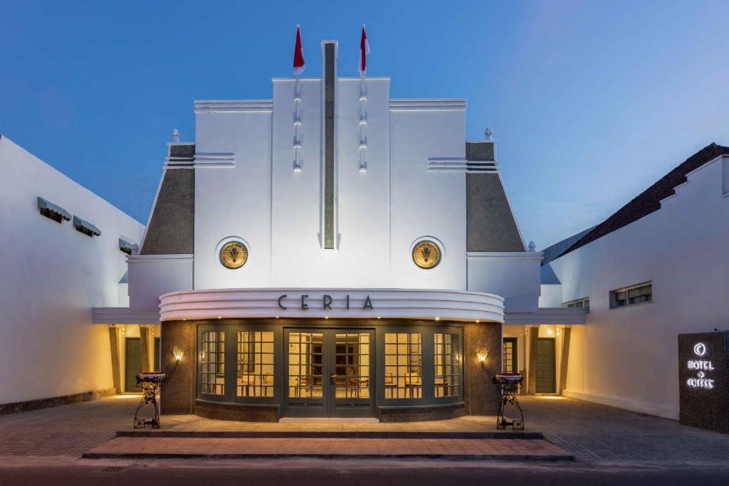 een wit gebouw met een bord erop bij CERIA HOTEL at Alun Alun Yogyakarta in Yogyakarta