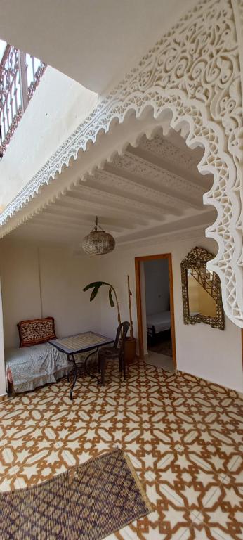 a living room with a white ceiling and a table at Riad chaoui house in Marrakech