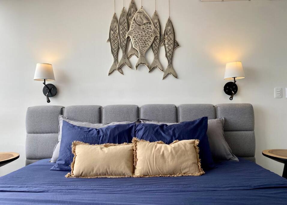 a bed with blue sheets and pillows in a room at ☆Brand new 2BR PH by CASA PARAISO☆ in Cancún
