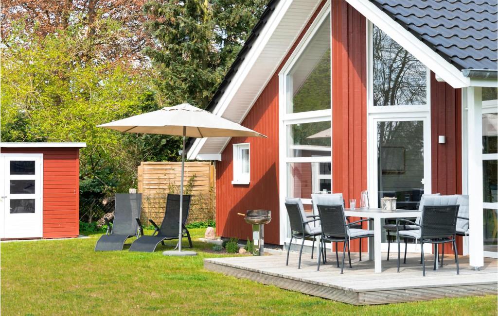 un patio con mesa, sillas y sombrilla en Lovely Home In Krems Ii-warderbrck With Sauna, en Göls