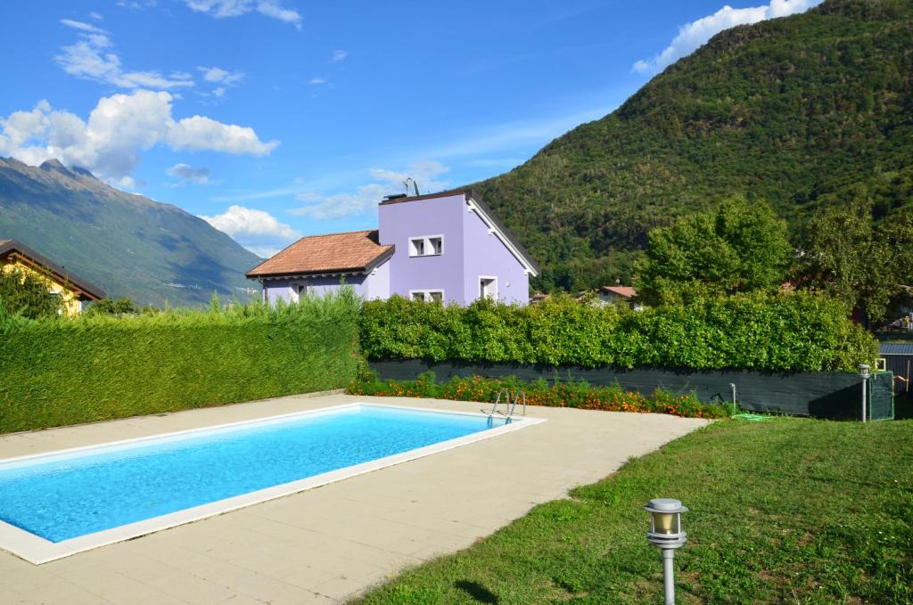 a house with a swimming pool in front of a house at "Lake & Mountain" Summer House in Colico
