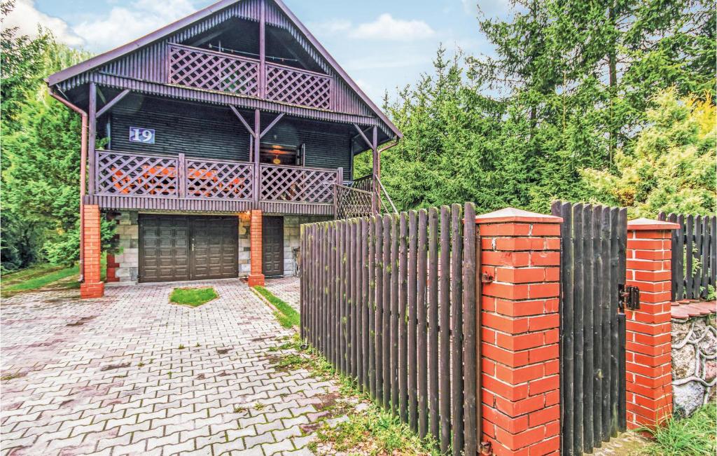 a wooden fence in front of a house at Awesome Home In Dabrwno With 3 Bedrooms in Dąbrówno