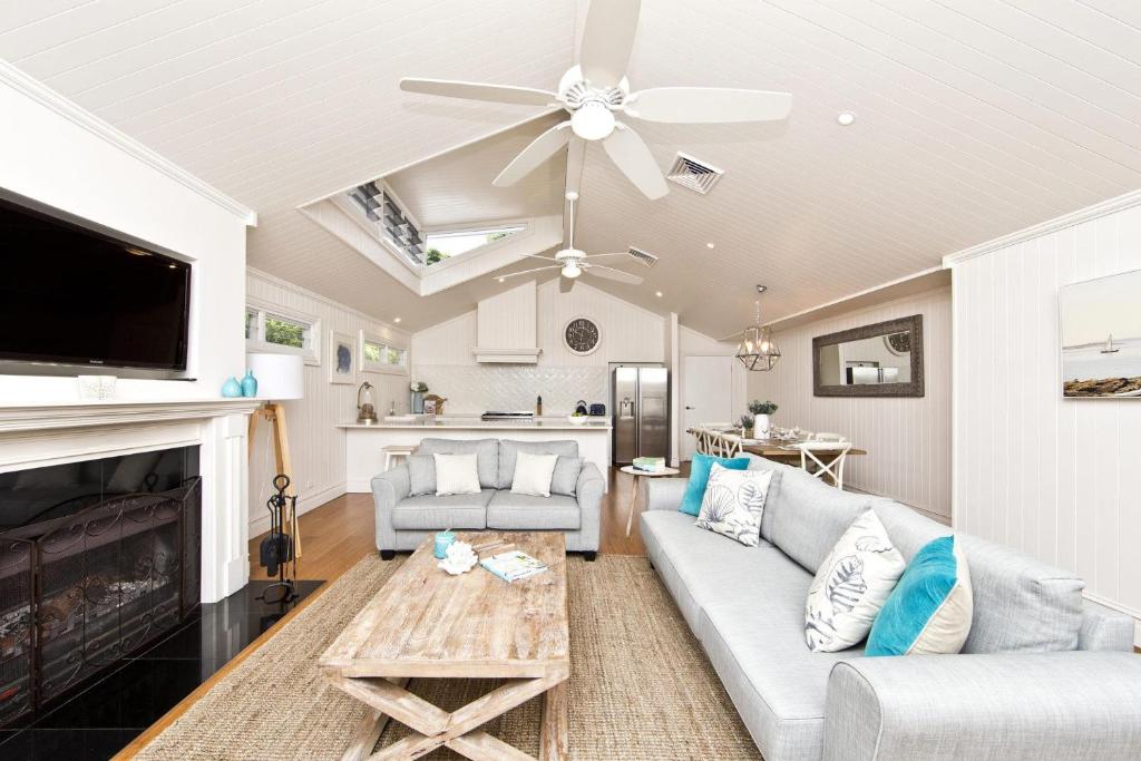 - un salon avec un canapé et une cheminée dans l'établissement The Hamptons Beach House near Dutchie's walk to Nelson Bay, à Nelson Bay
