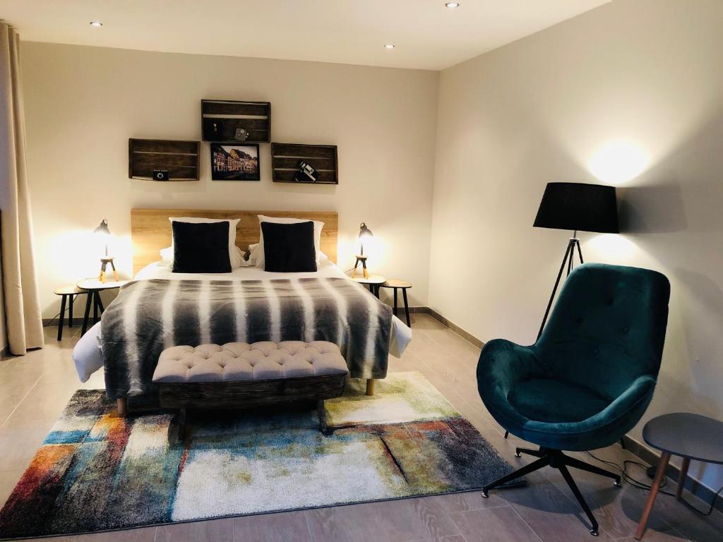 um quarto com uma cama e uma cadeira verde em Zewwelatreppler - La Grange aux Petits Oignons - Chambre Rainette em Sélestat