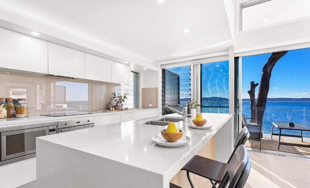 a kitchen with a view of the water at Baydream on the Beach - With Breathtaking Water Views in Corlette