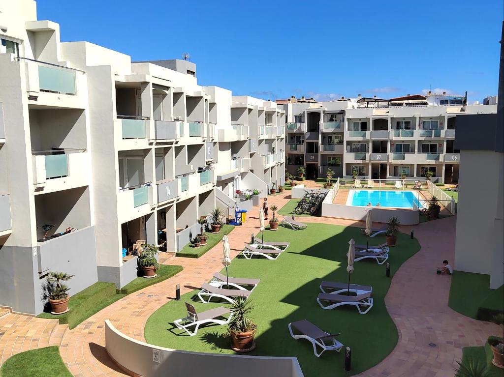 an aerial view of an apartment complex with a swimming pool at Rizi Corralejo Sun in Corralejo